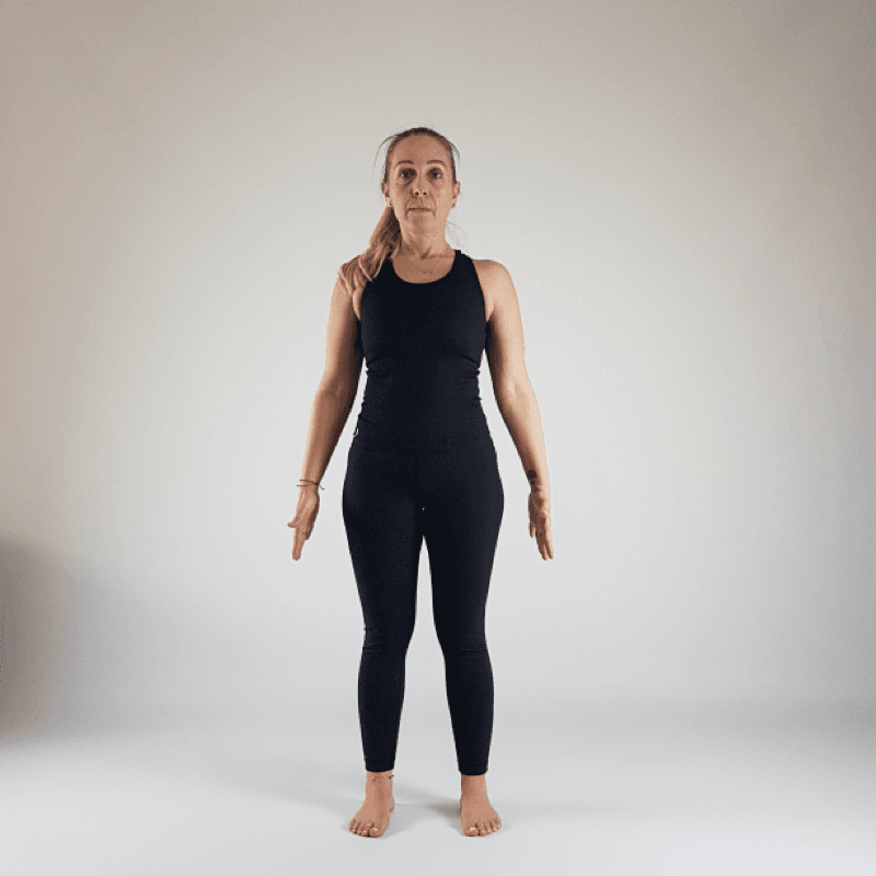 Yoga practitioner standing in Mountain Pose with perfect vertical alignment