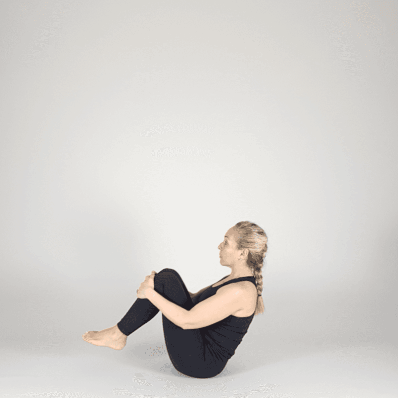 Practitioner holding full boat pose.