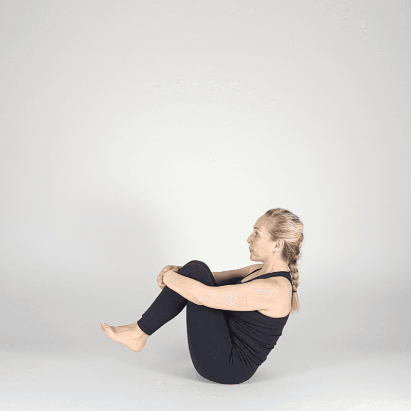 Yoga practitioner holding Extended Boat Pose.