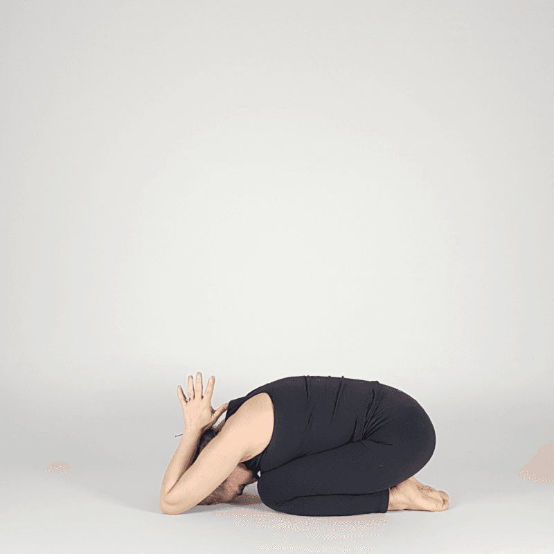 Yoga practitioner resting elbows in child's pose.