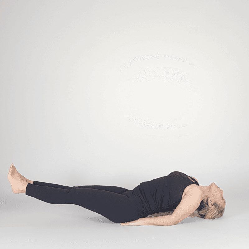 Yoga practitioner lifting legs while lying on back.