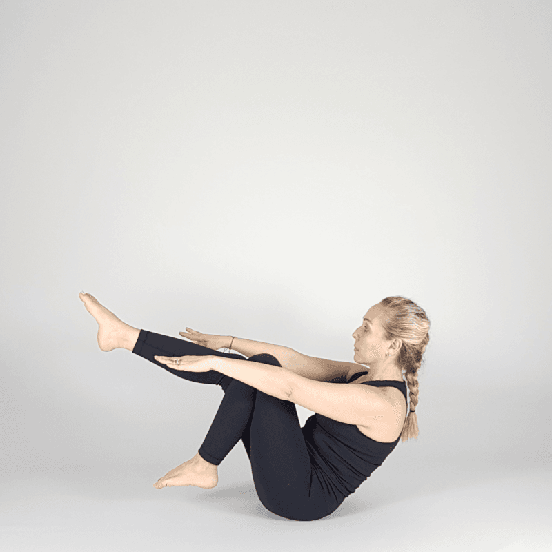 Yoga practitioner preparing for boat pose.