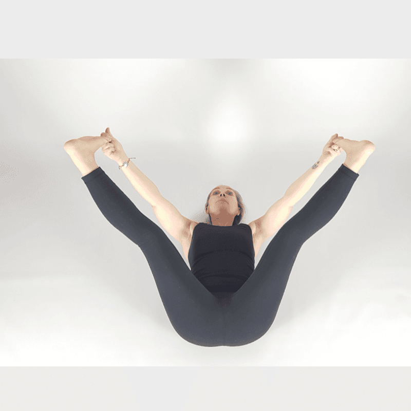 Yoga practitioner in headstand preparation position.
