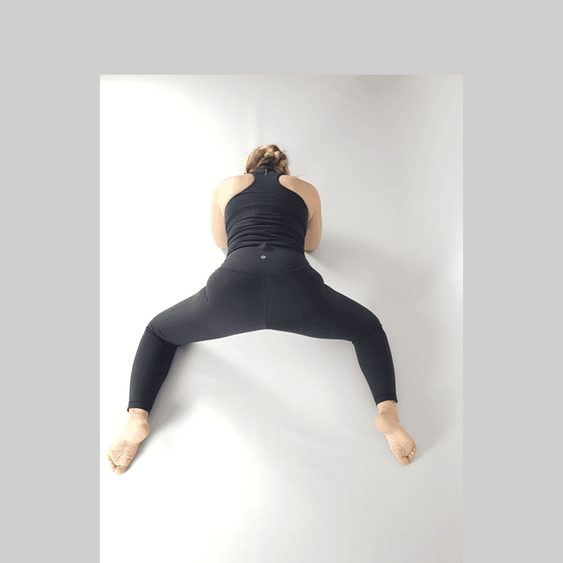 Yoga practitioner resting in Wide-Knee Rest Pose