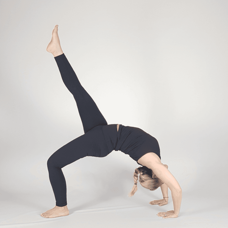 Yoga practitioner in One-Leg Wheel Pose with leg raised