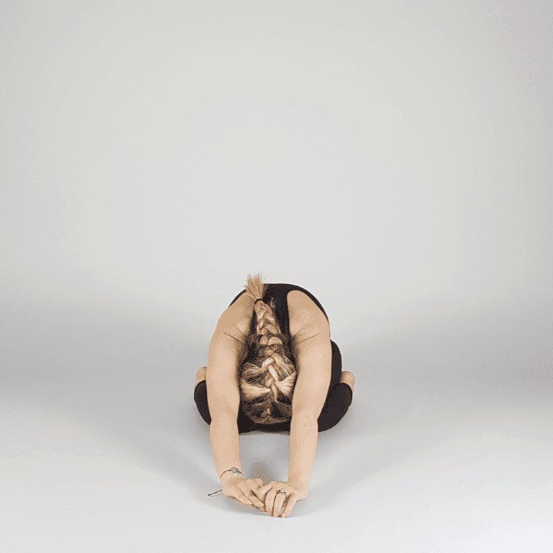 Yoga practitioner in butterfly forward fold.