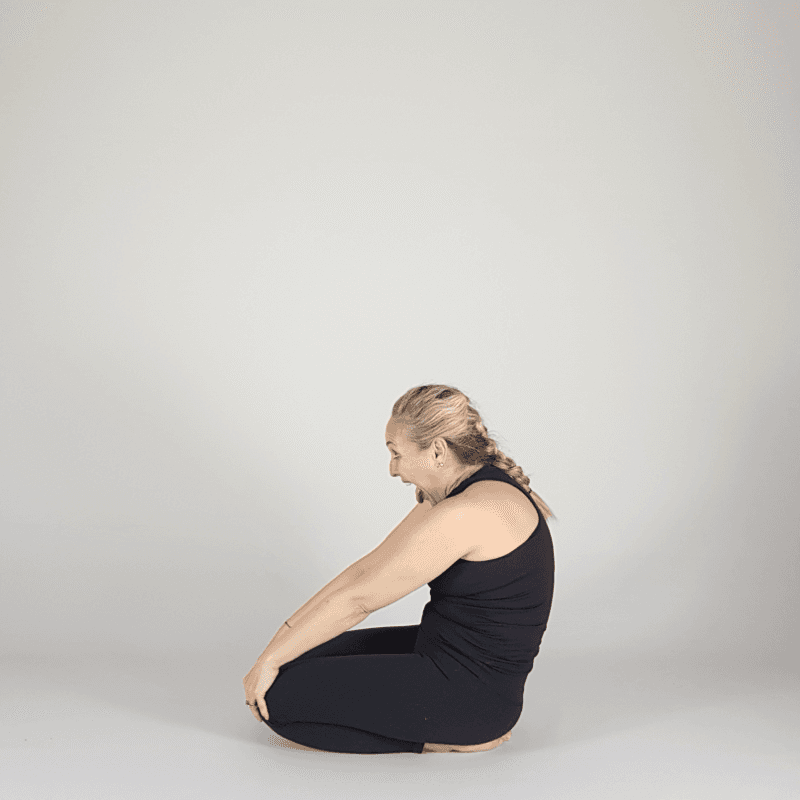 Yoga practitioner performing a gentle seated twist.