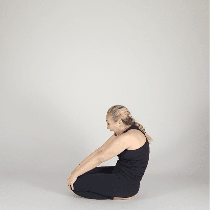 Yoga practitioner demonstrating a seated shoulder opener.