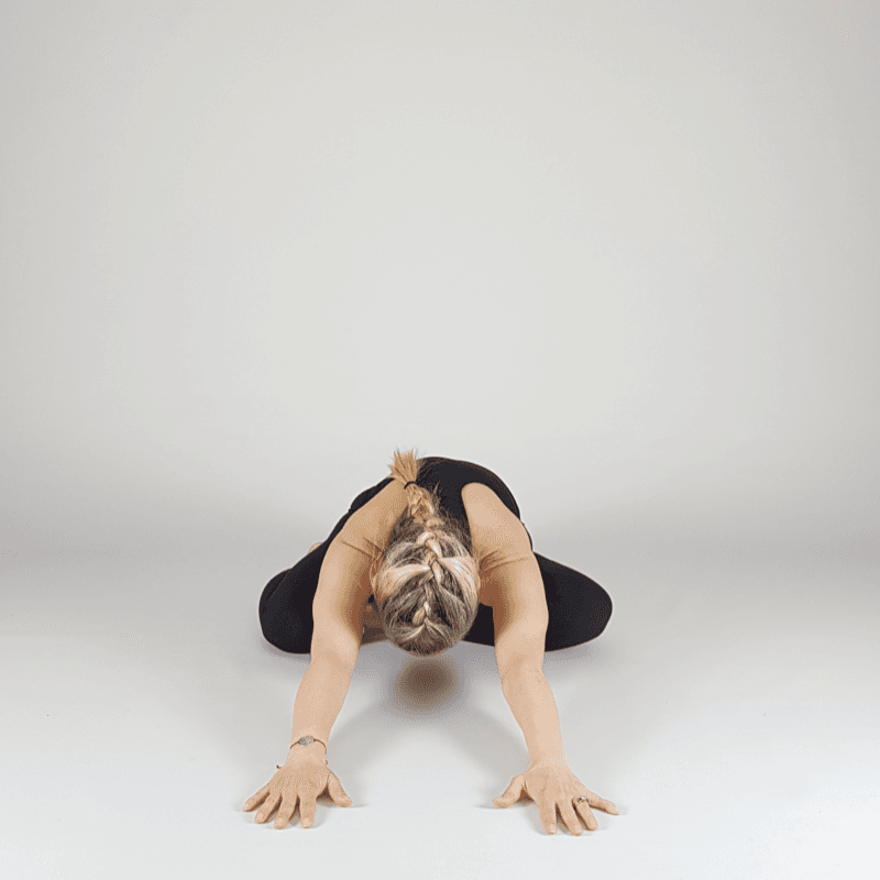Yoga practitioner in wide seated forward fold.