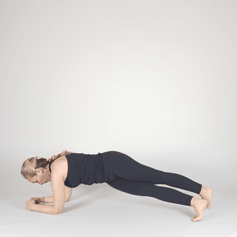 Yoga practitioner holding Forearm Plank with steady form