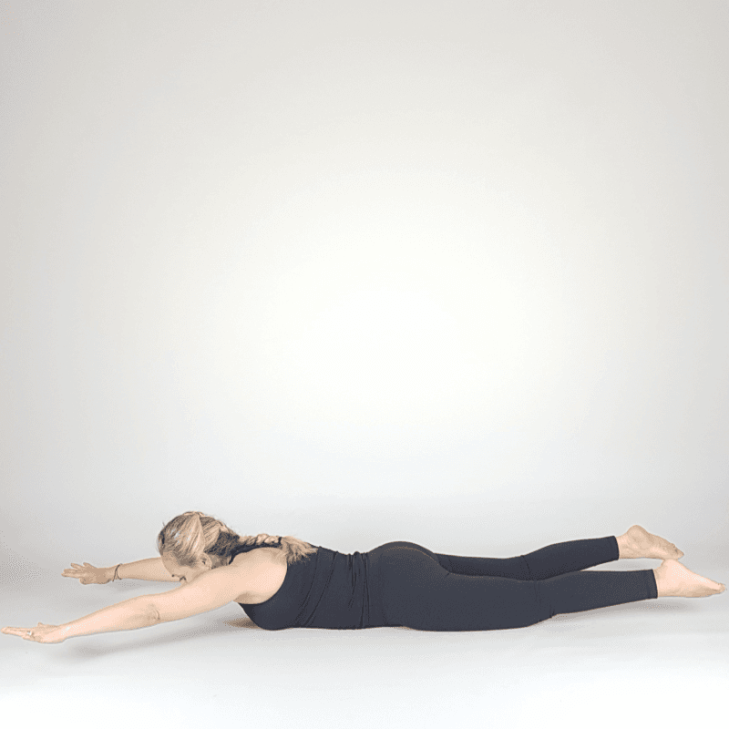 Yoga practitioner holding ankles in Bow Pose.