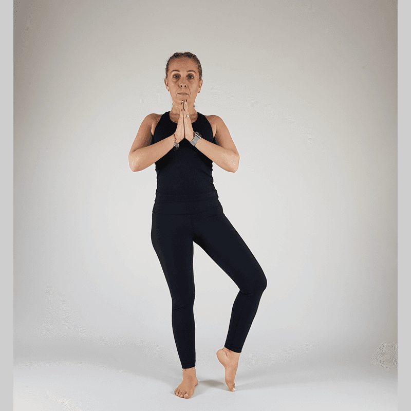 Yoga practitioner in Tree Pose with toes of lifted foot touching the ground for support