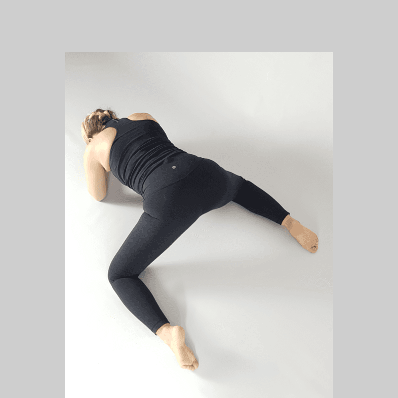 Yoga practitioner in Wide-Knee Side Stretch reaching to one side