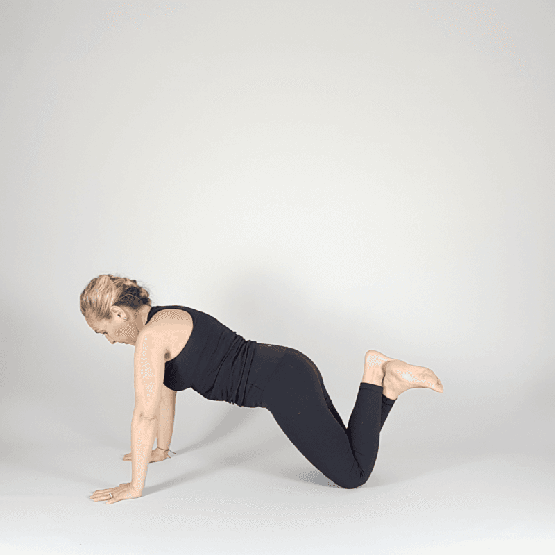 Yoga practitioner bending knees in Tabletop position