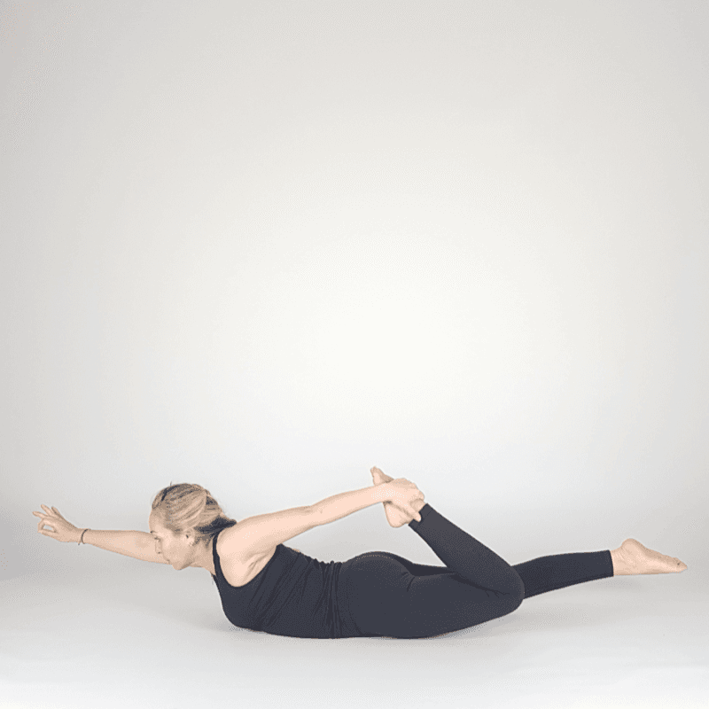 Yoga practitioner in One-Legged Bow Pose with one leg extended.
