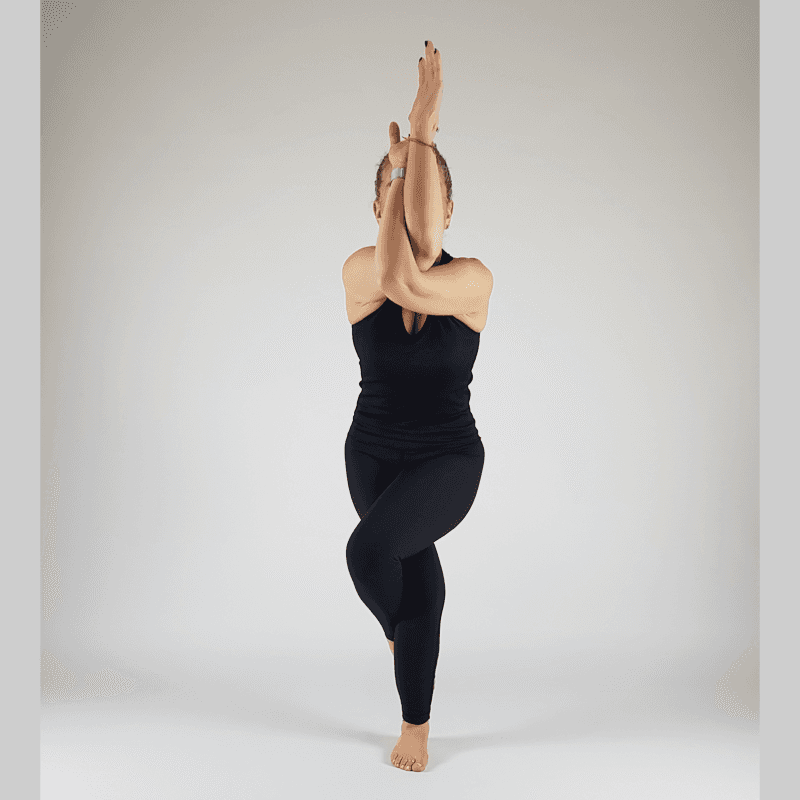 Yoga practitioner in Eagle Pose with wrapped arms and legs in standing balance