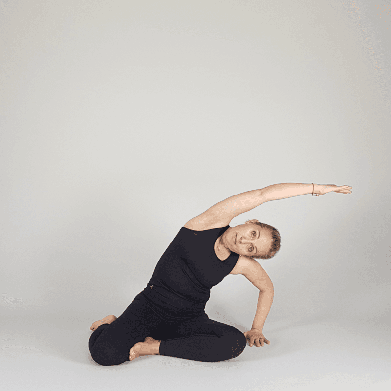 Yoga practitioner in a restorative side bend.