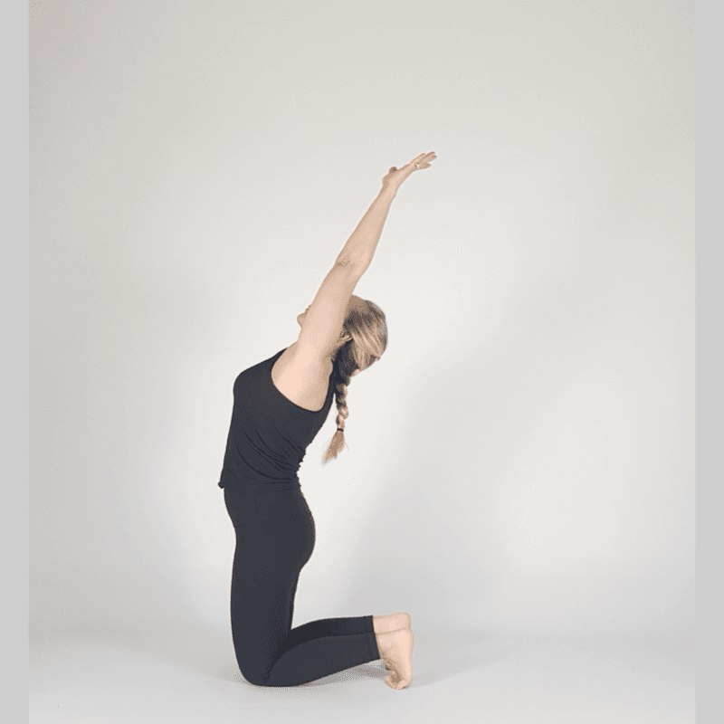 Yoga practitioner in Camel Pose with arms reaching up