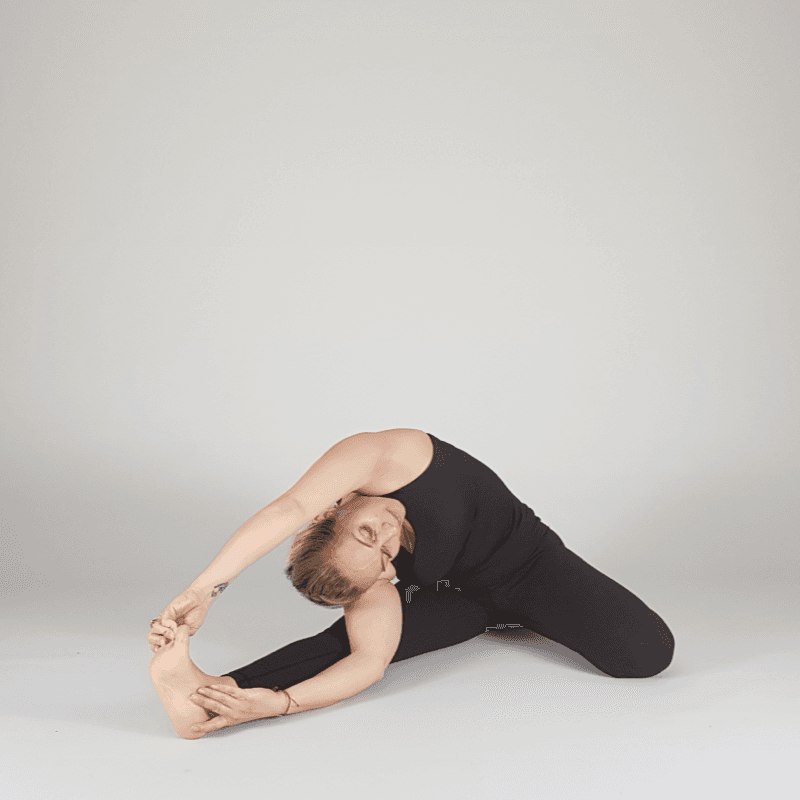 Yoga practitioner performing a bound seated side stretch.