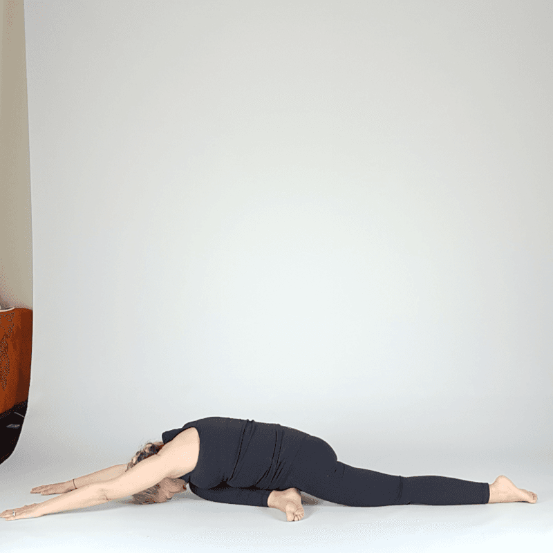 Yoga practitioner in a low lunge split preparation.