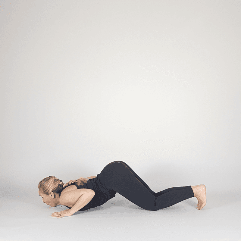 Yoga practitioner in Modified Chaturanga with knees down