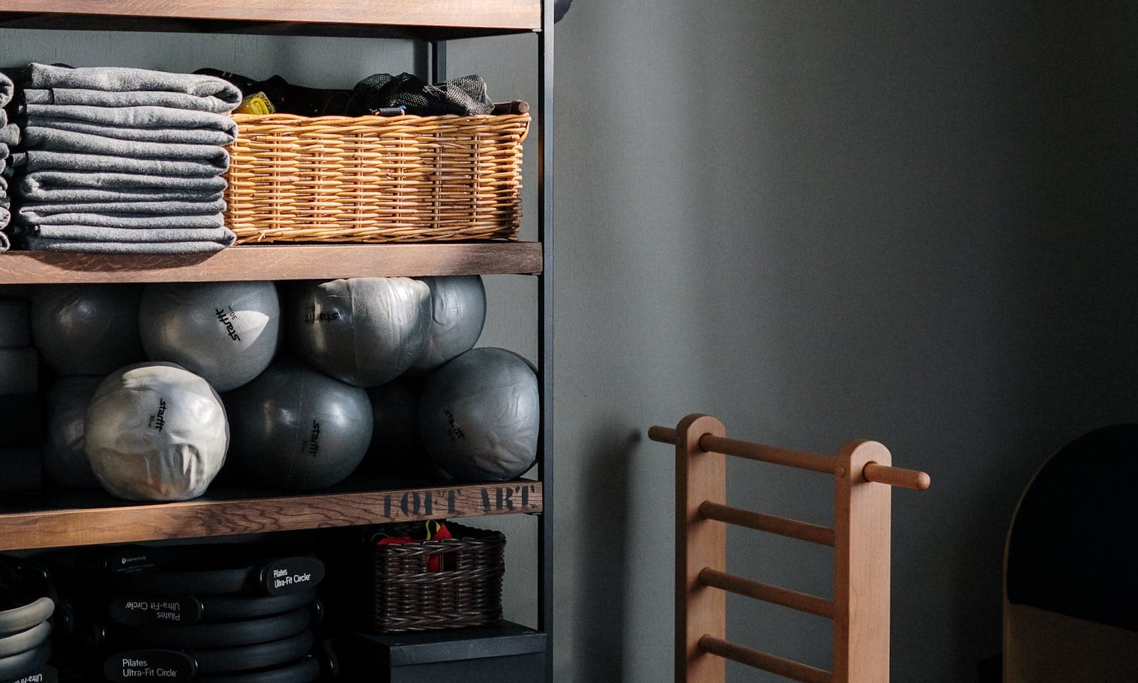 A yoga towel laid over a mat in a sunlit studio — hot yoga grip towel