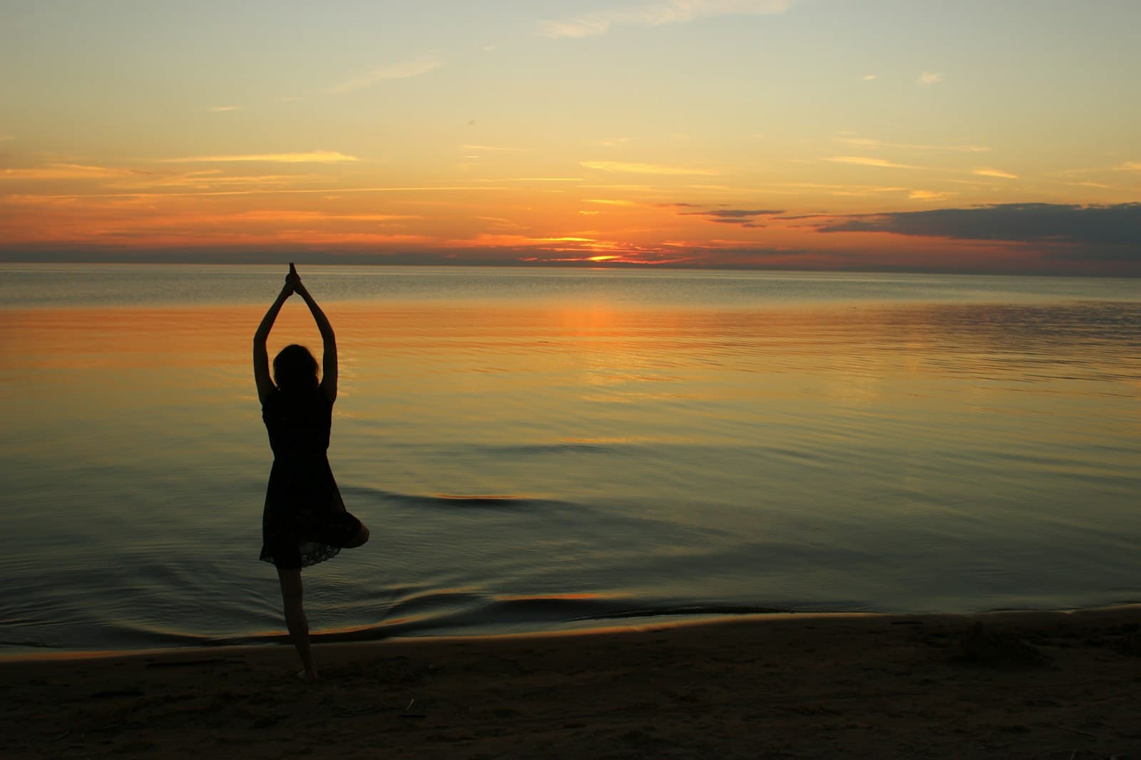 Yoga student standing with one hand on a wall for scoliosis assessment