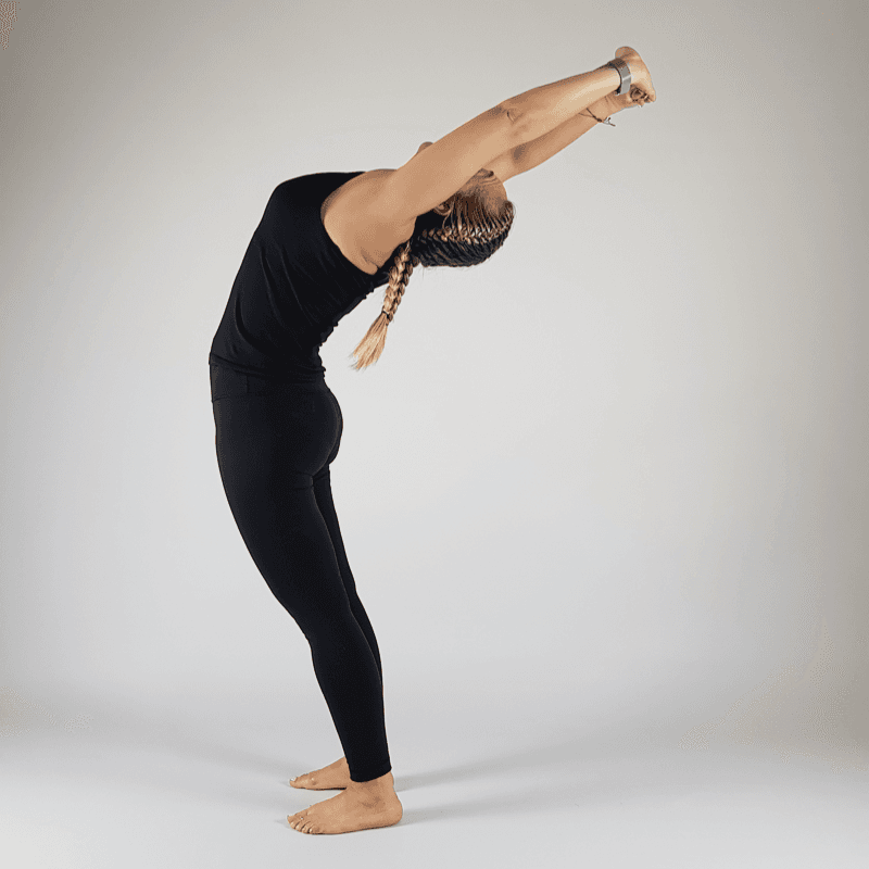 Standing Side Stretch bending to the right with arms overhead.