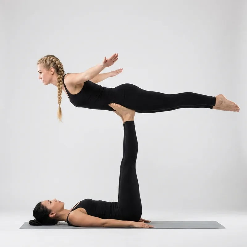 Acro yoga pose for 2 people — High Flying Bird, the flyer balanced face down with arms out like wings on the base's feet
