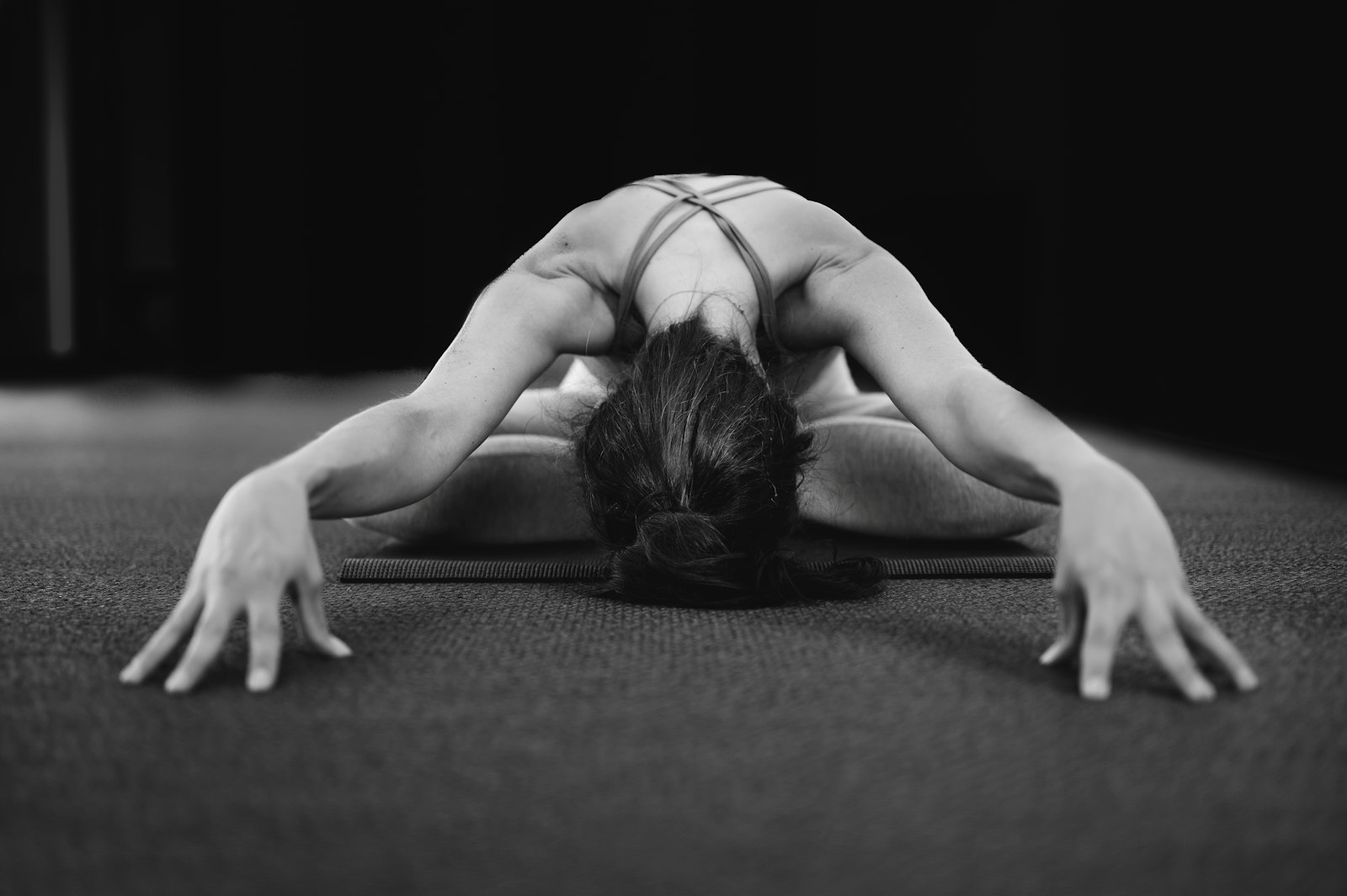 Yoga practitioner in downward dog at sunset